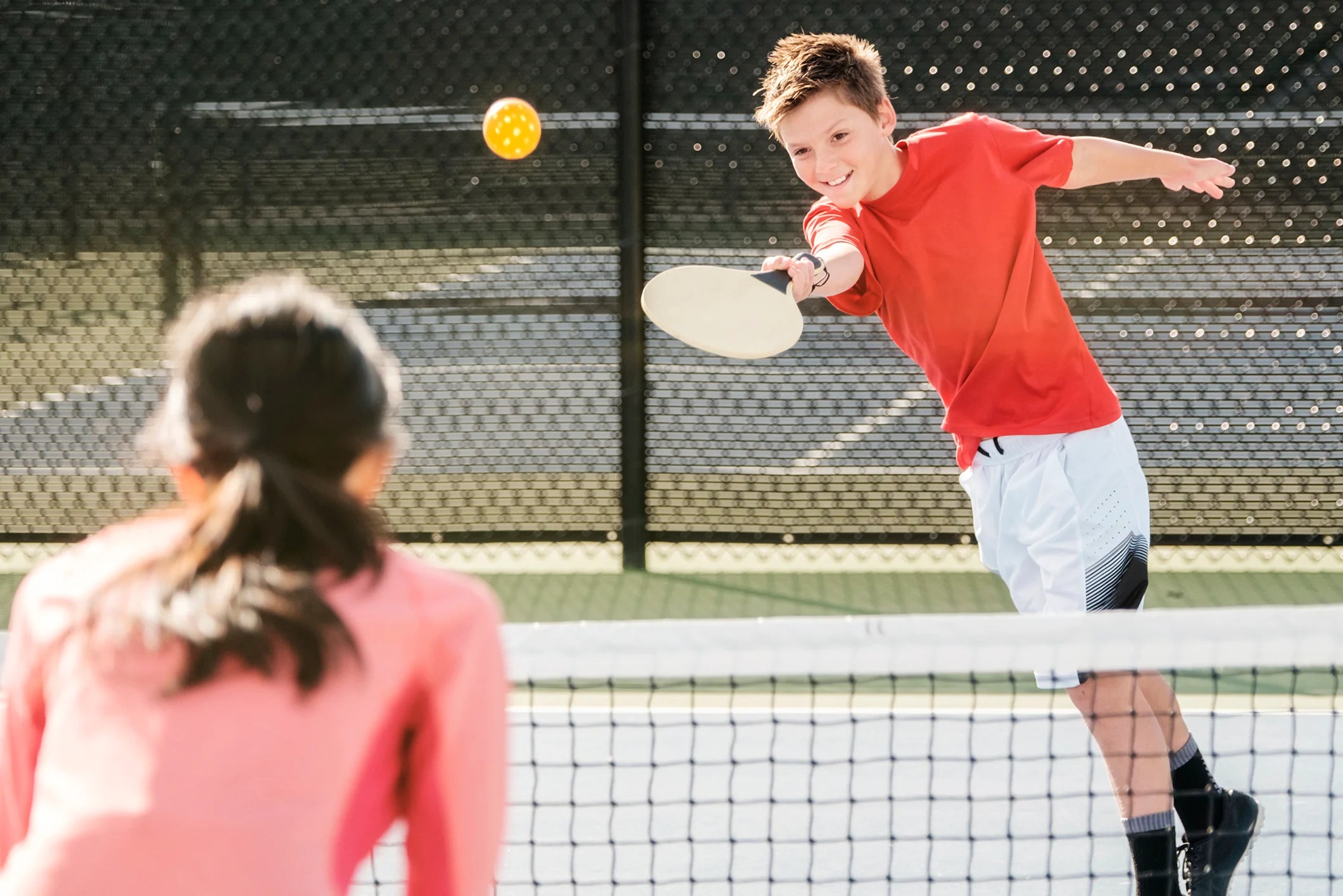 youth playing pickleball